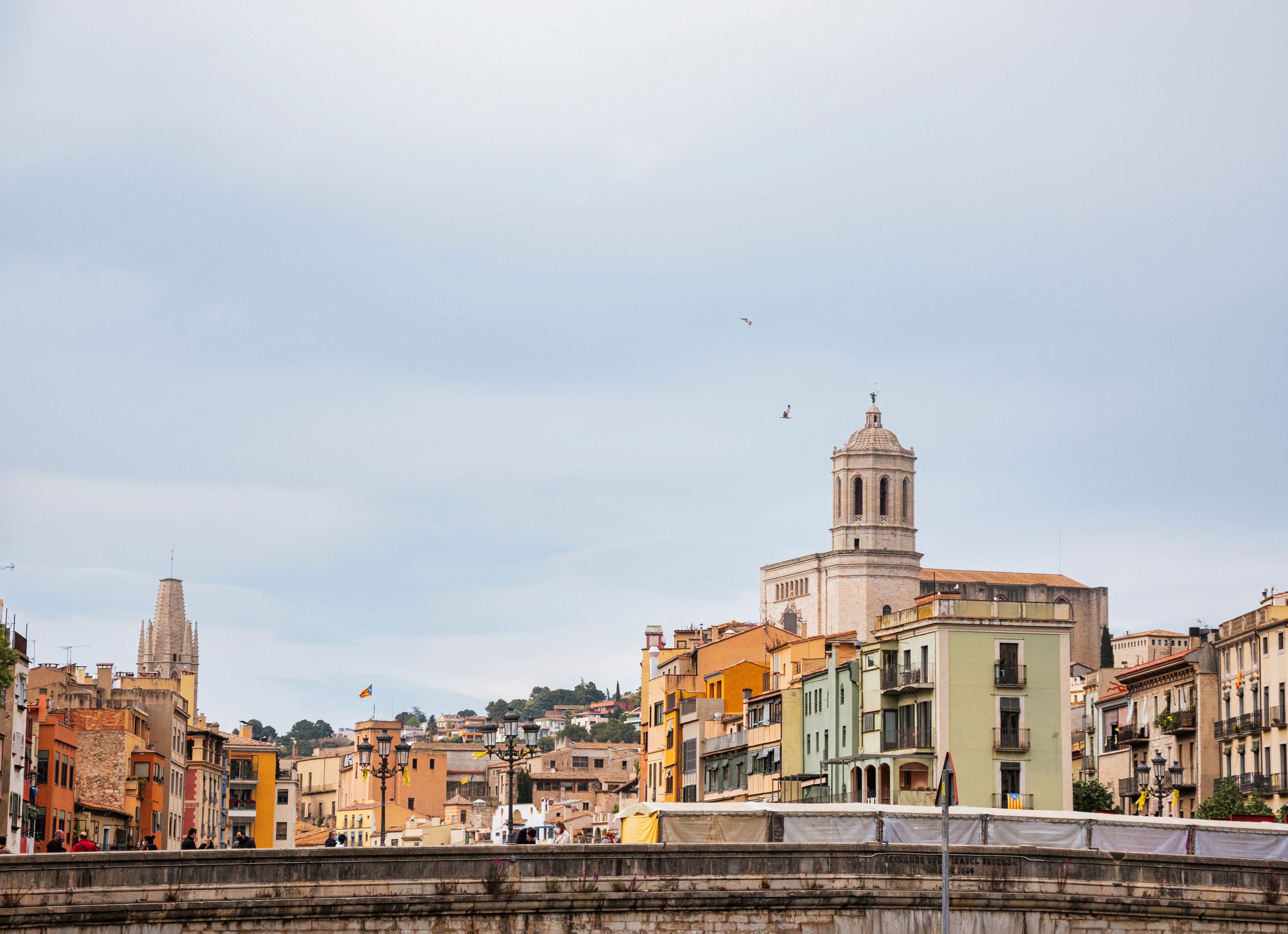 Discover the charm and historic beauty of Girona's skyline with its colorful buildings and iconic cathedral.