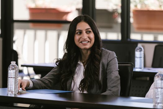 Smiling businesswoman attentively listening during a professional meeting indoors.