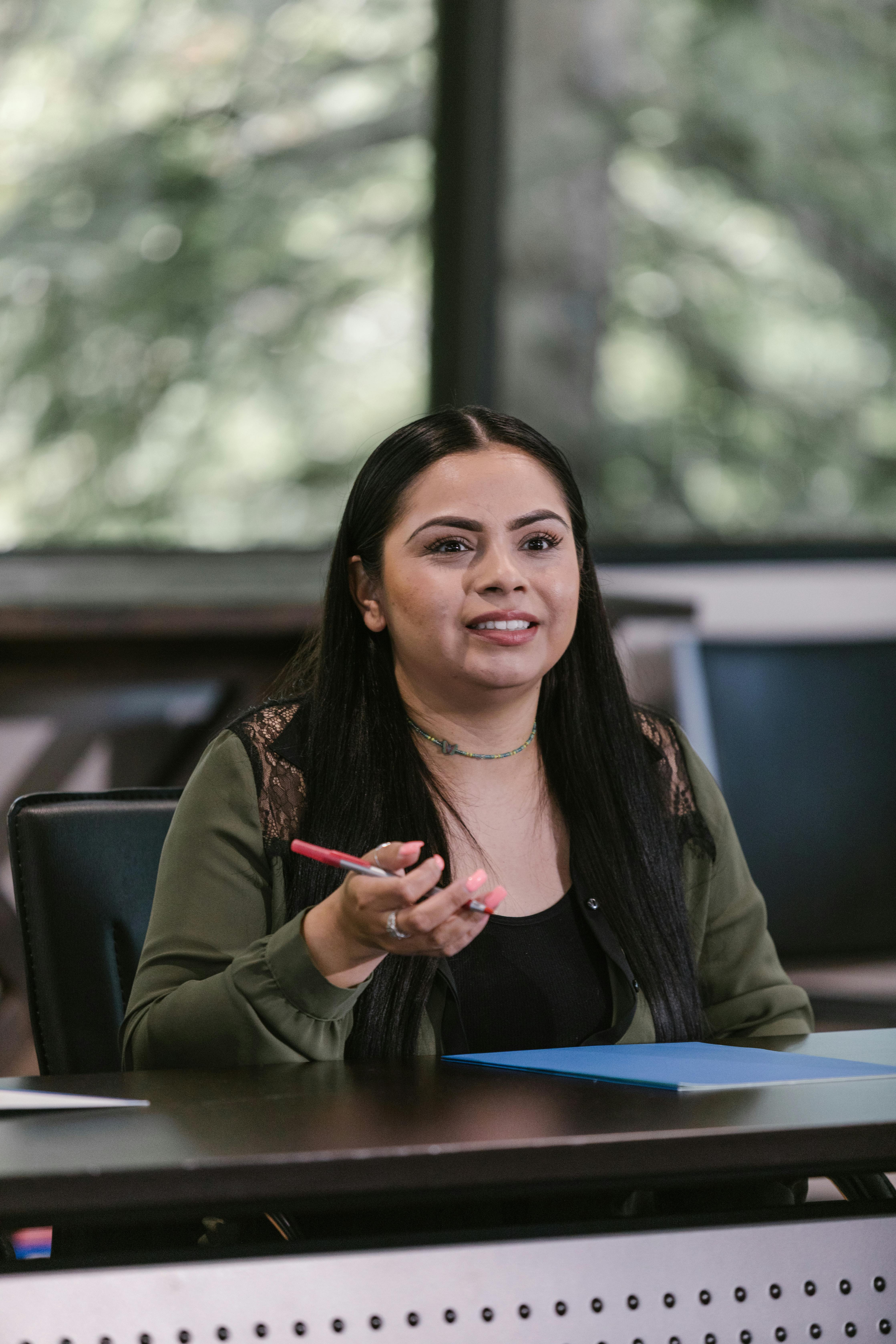 female professional sitting beside a wooden table