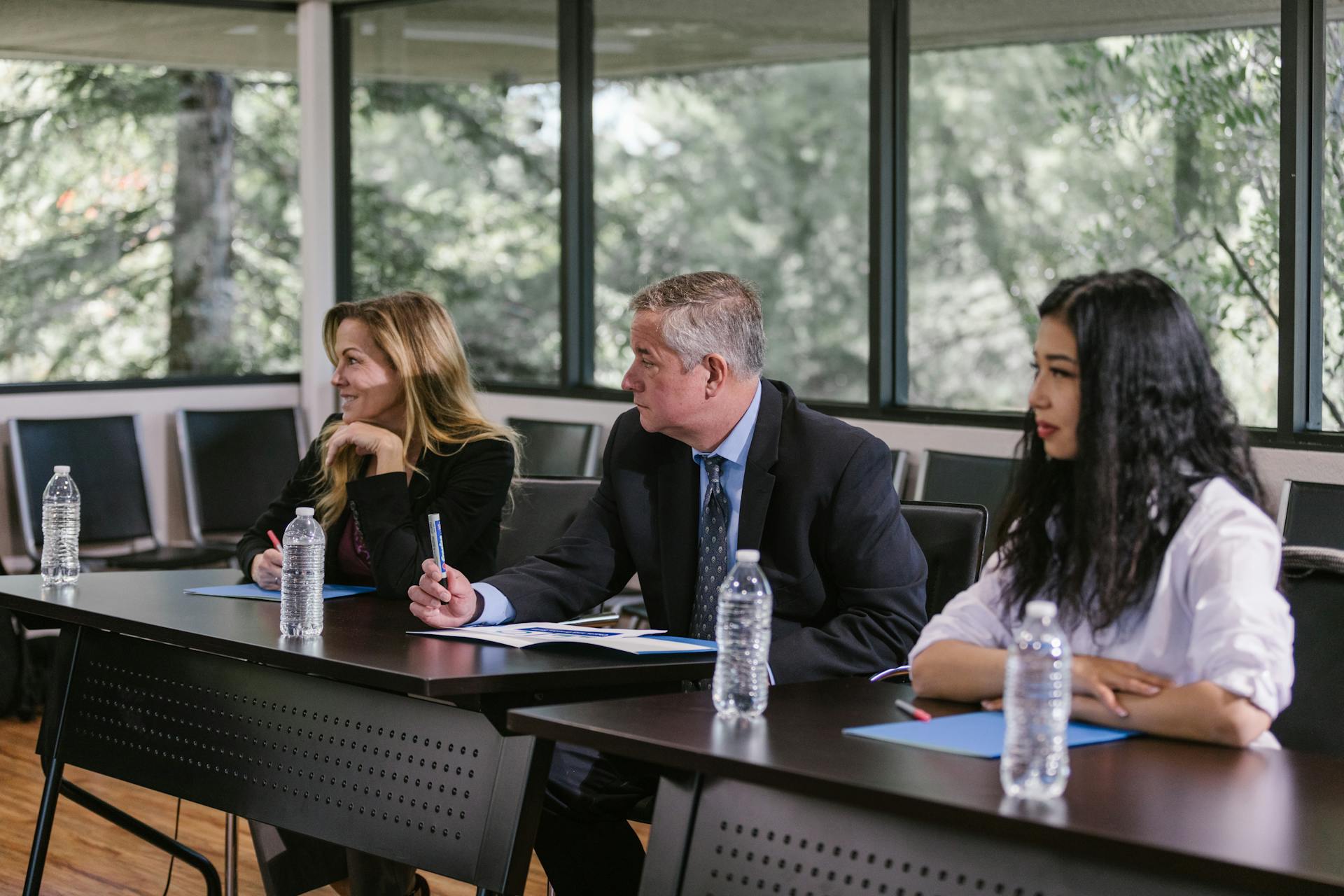 Diverse professionals engaged in a business meeting in a modern conference room.