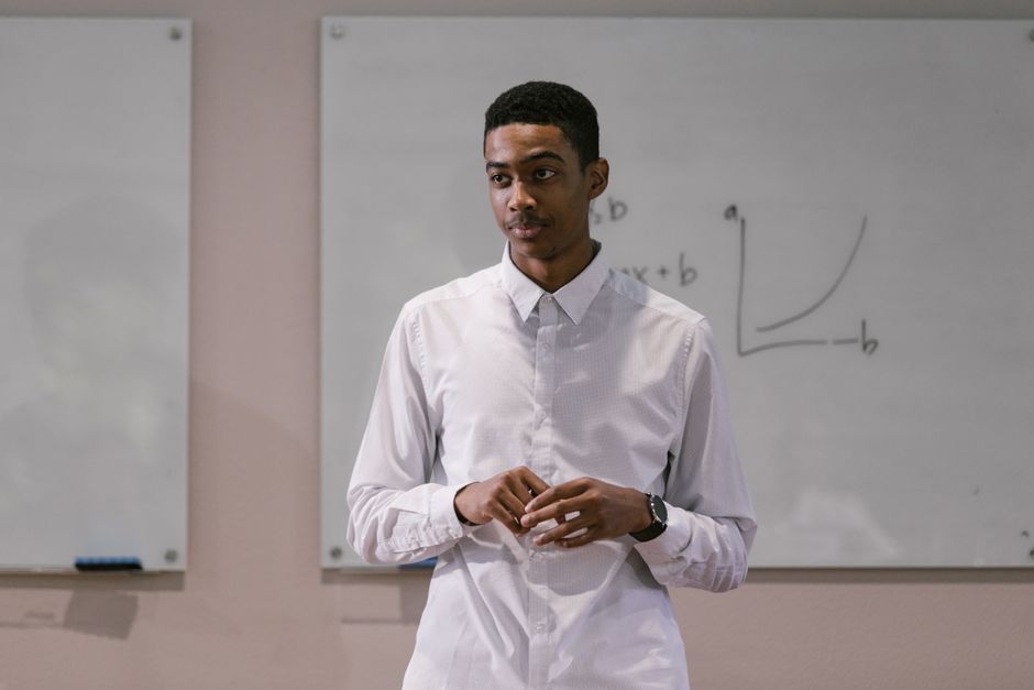 Confident young man presenting graphs and data in a business meeting setting. Confident young man presenting graphs and data in a business meeting setting.