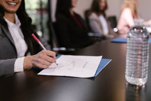 A Person Writing on White Paper