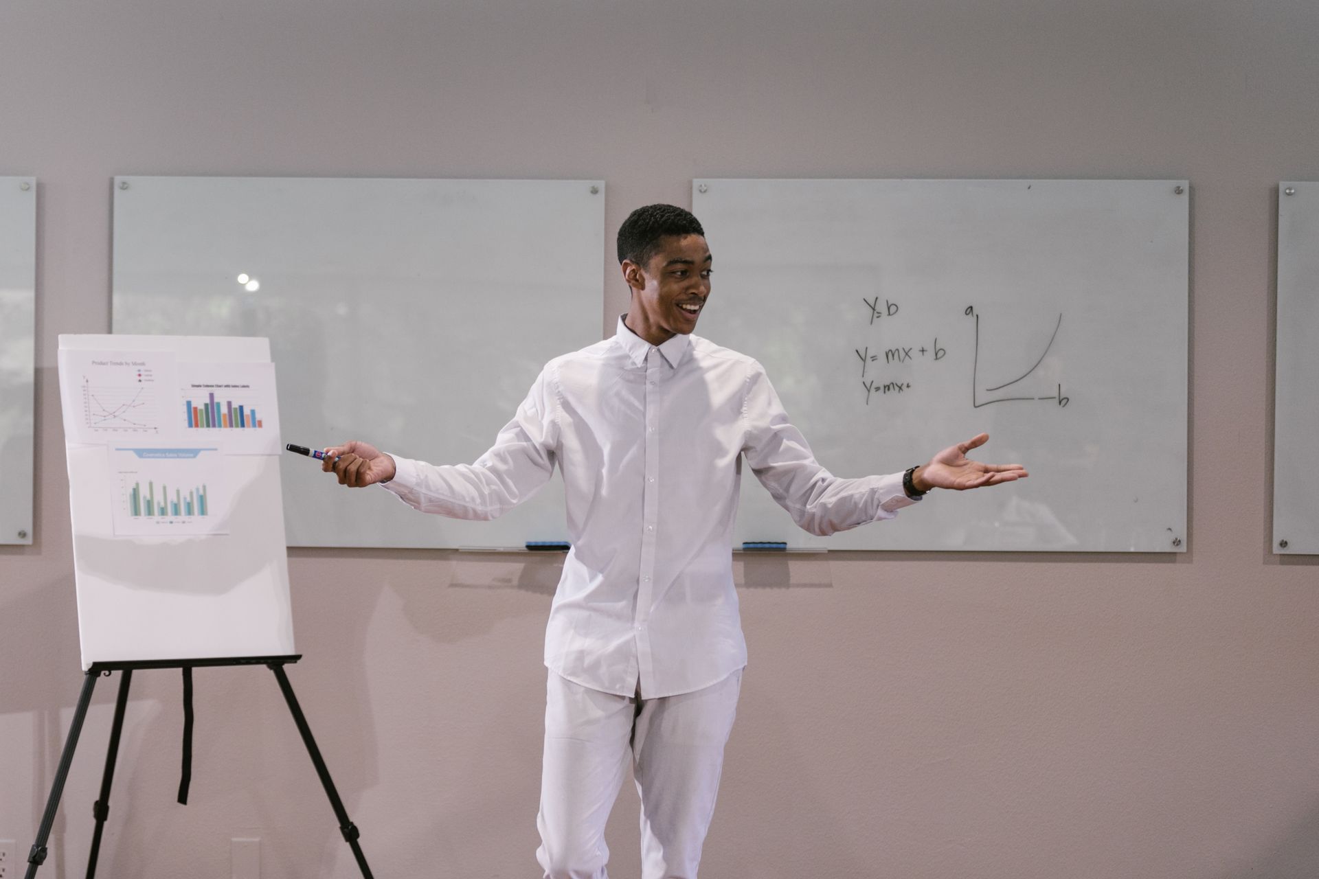 A Man in White Long Sleeve Presenting Report in the Meeting Room
