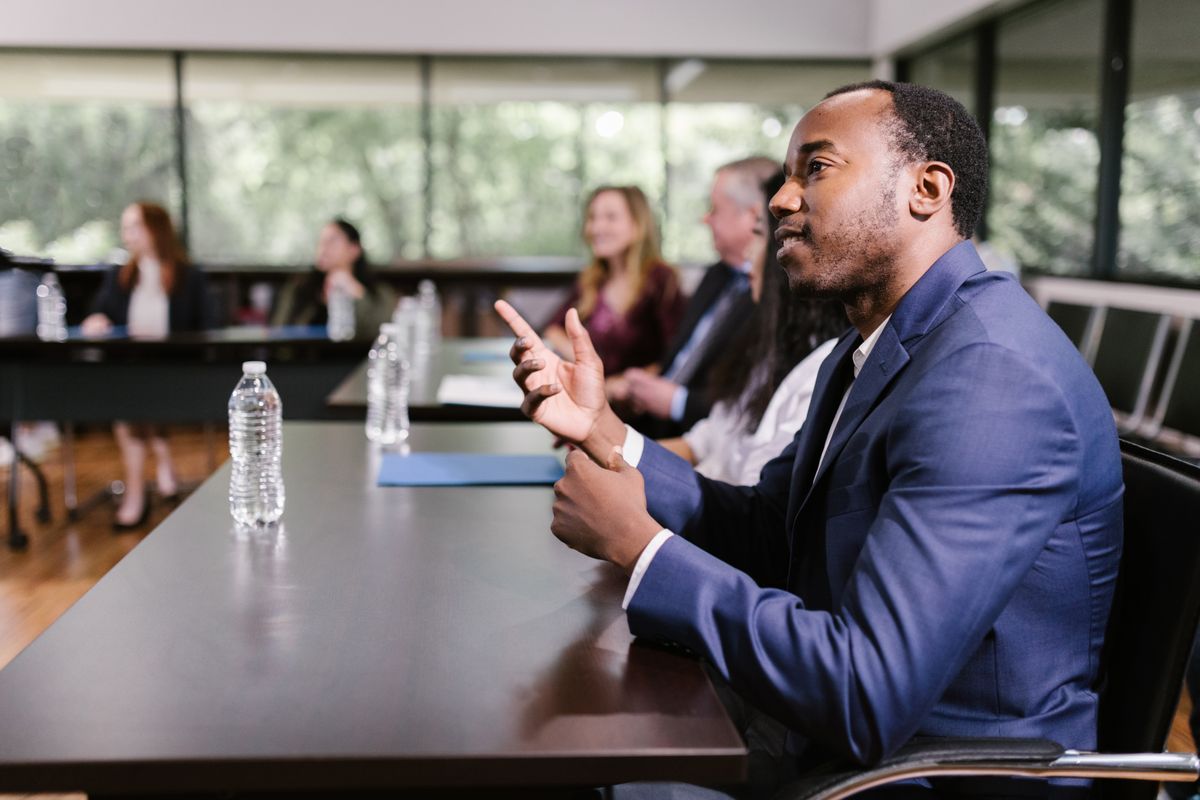 Professional in a strategy meeting speaking to a diverse group