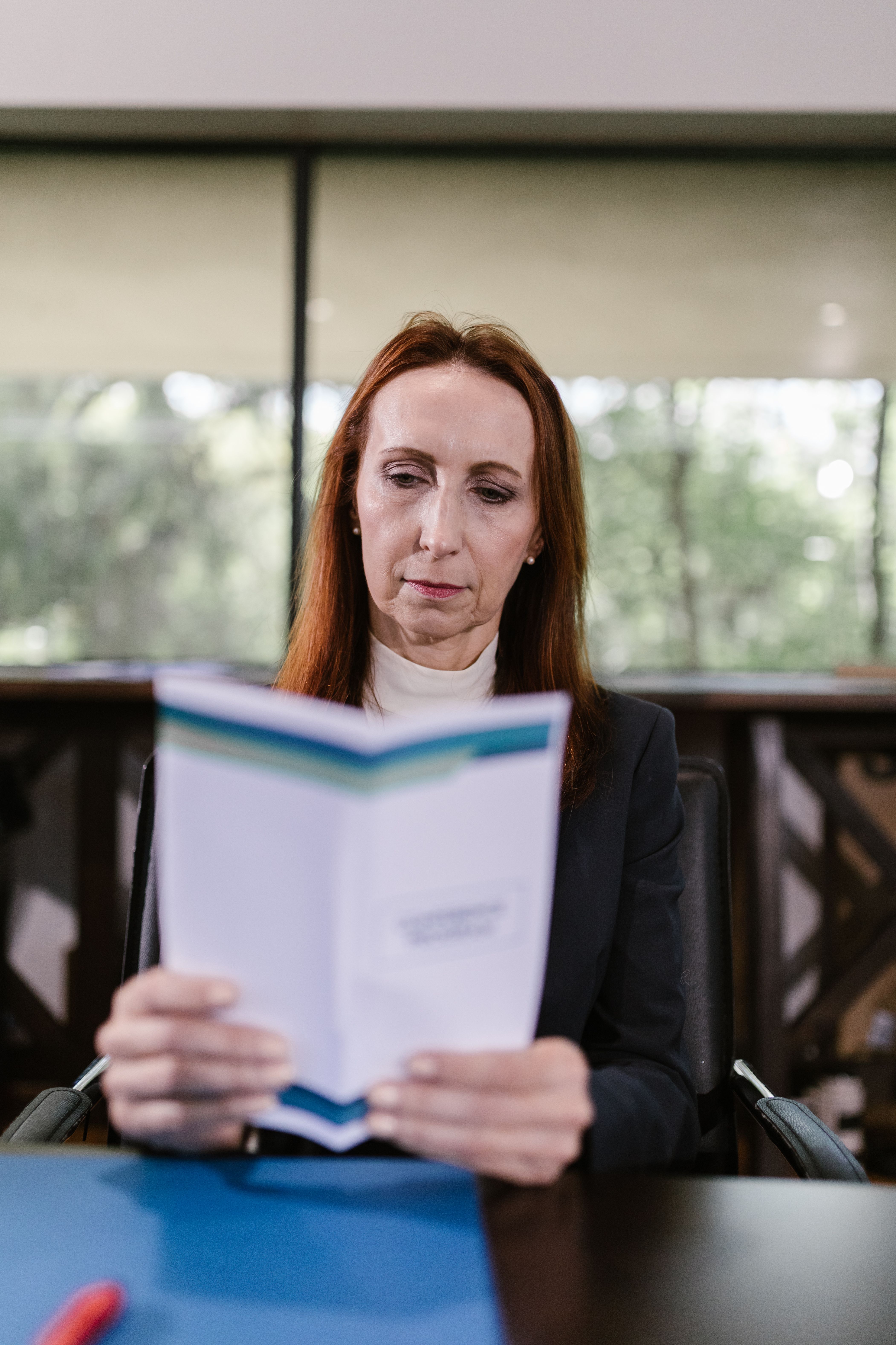 ACSON consultant reviewing policy documents in a modern office