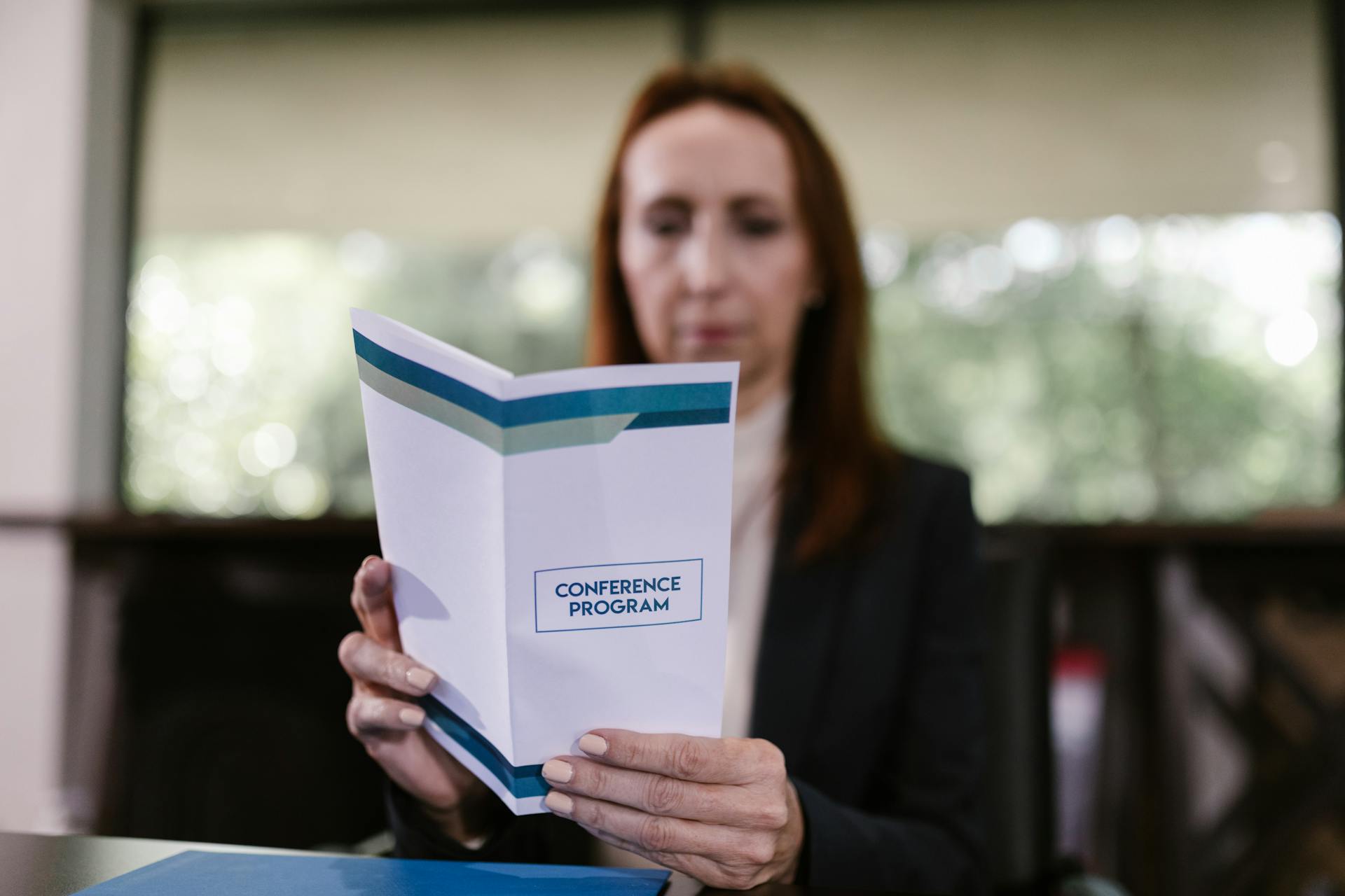 A Woman Holding a Conference Program