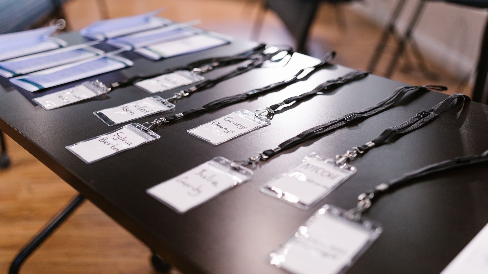 Badge Printing: Your Ultimate Guide to Custom Identification 5 Close-up of name tags and folders laid out for a conference or meeting — badge printing