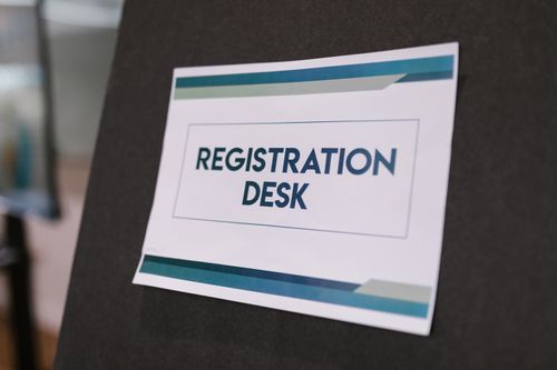 Attendees checking in at a conference registration desk — photo by RDNE Stock project on Pexels