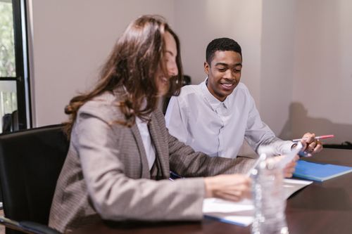 Free Two professionals engaged in a corporate meeting, sharing ideas and insights. Stock Photo