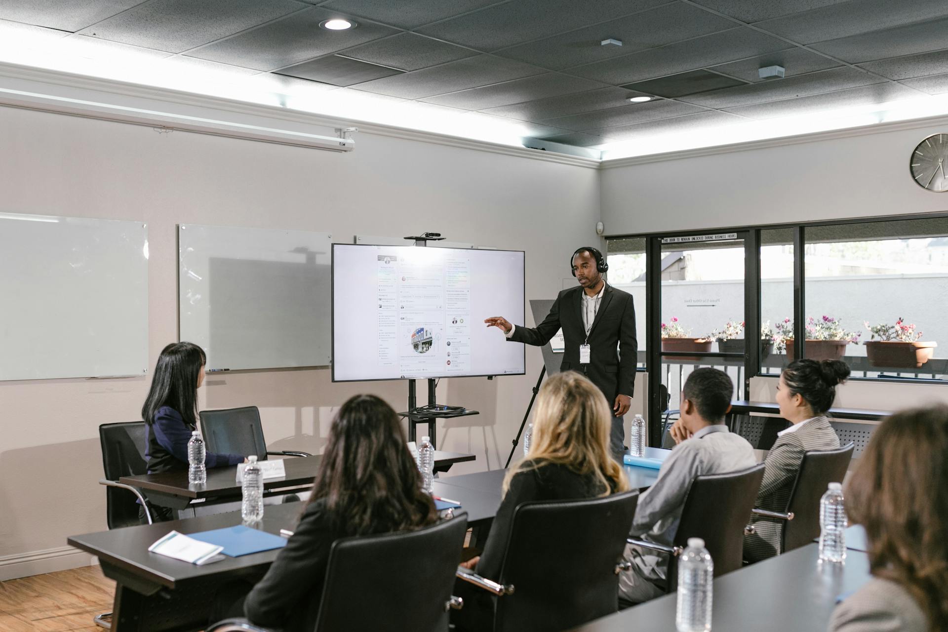 Business presentation with diverse team in a modern conference room setting.