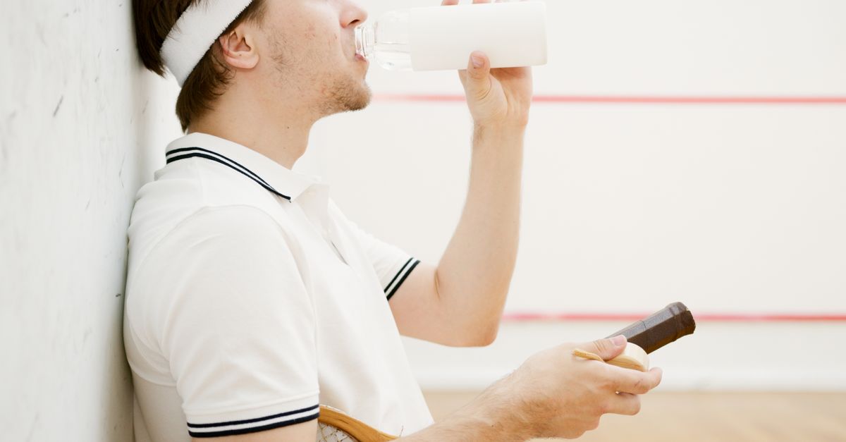 Side View of a Squash Player Drinking Water · Free Stock Photo