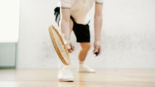 A Person Holding a Squash Racket