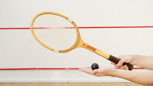 Free A Person Holding a Tennis Racket and a Ball Stock Photo