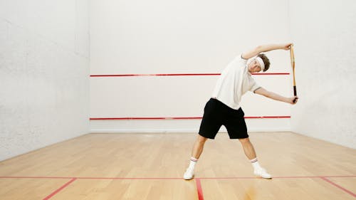 Free A Man Holding a Tennis Racket while Doing Exercise Stock Photo