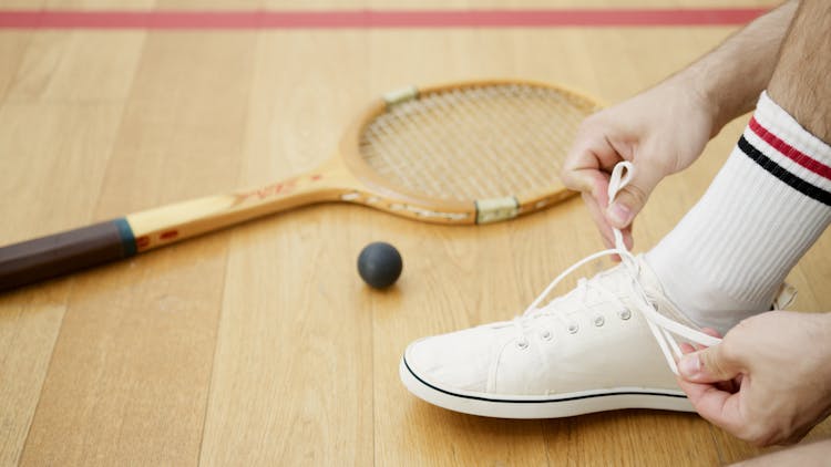 A Person Tying Shoe Lace