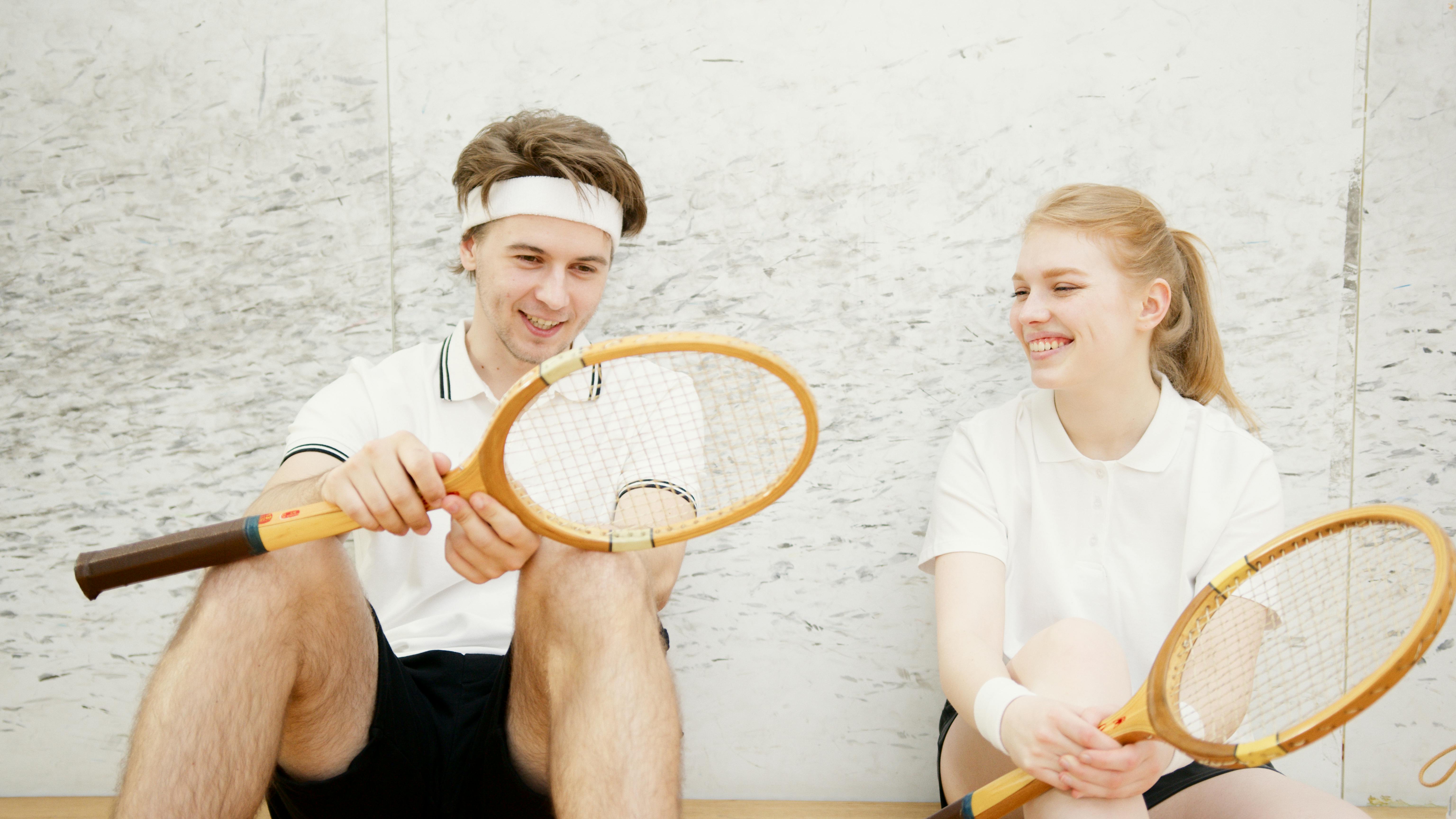 young squash players sitting together