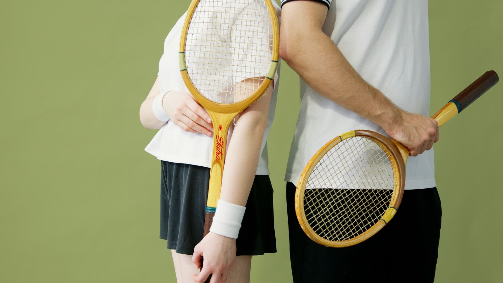 Person outdoors adjusting an elbow support before activity