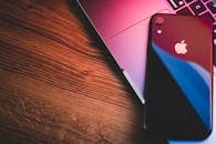 A Black Cell Phone on a Laptop