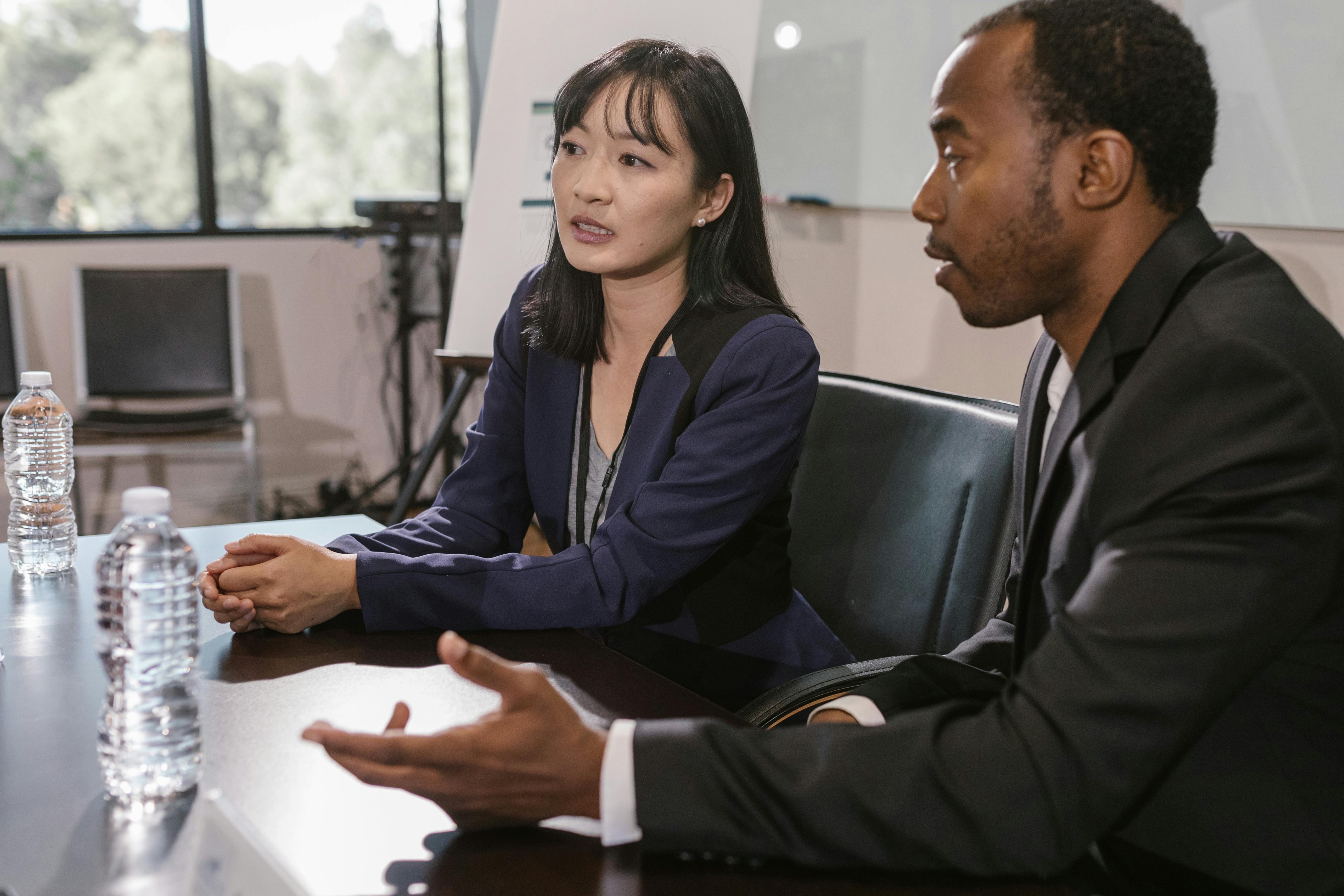 a man and woman having a meeting in the office