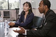 A Man and Woman Having a Meeting in the Office