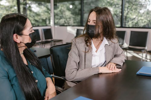 Colleagues Having a Conversation while Wearing Face Masks