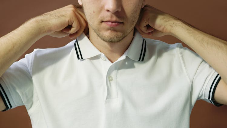 Man Touching T-Shirt Collar