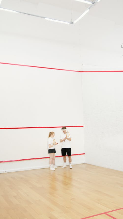 Free People in the Wooden Court Holding Rackets Stock Photo