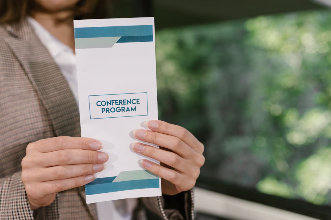 Free A Person Holding a Paper with Printed Texts Stock Photo