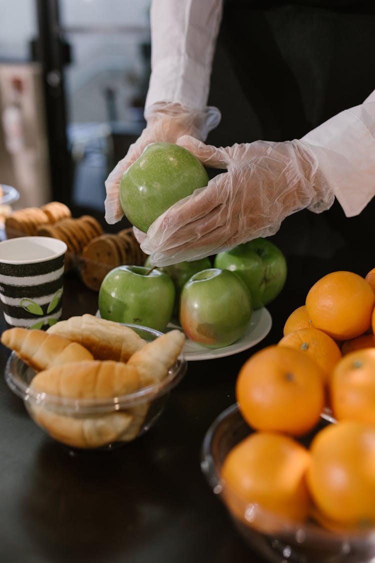 Person Holding A Green Apple