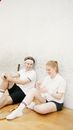 2 Women Sitting on Brown Wooden Bench