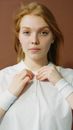 A Woman Fixing Her Shirt Buttons