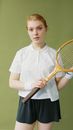 A Woman with Wooden Racket Wearing White Shirt