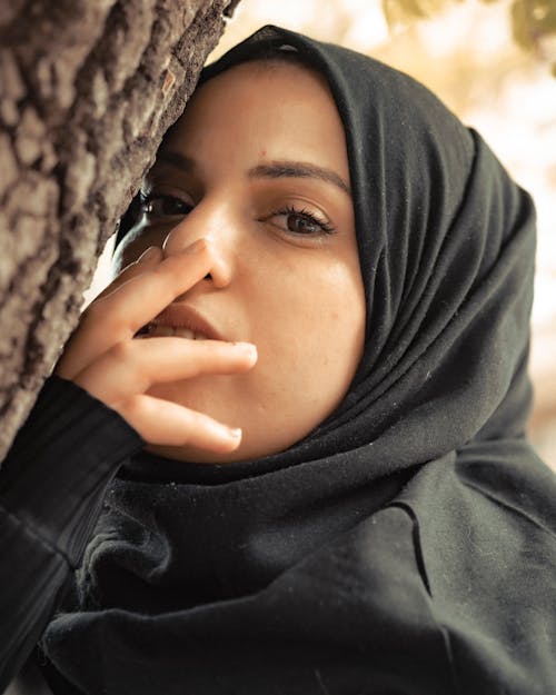 Woman in Black Hijab Covering Her Mouth
