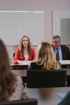 Professional meeting among colleagues discussing corporate strategies in conference room.