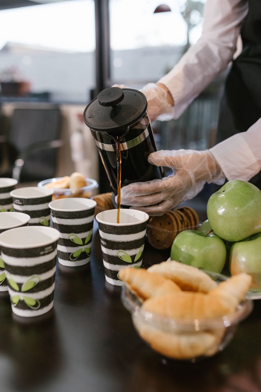 Barista pouring coffee for guests at a breakfast event