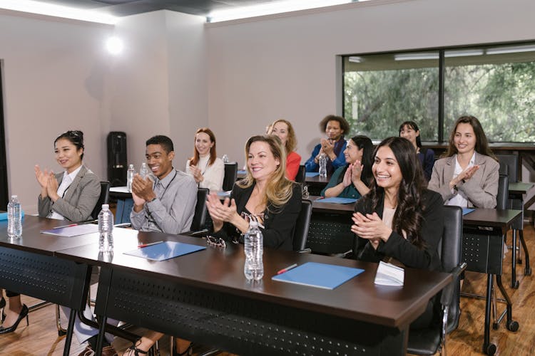 Group Of People In A Conference Room Clapping