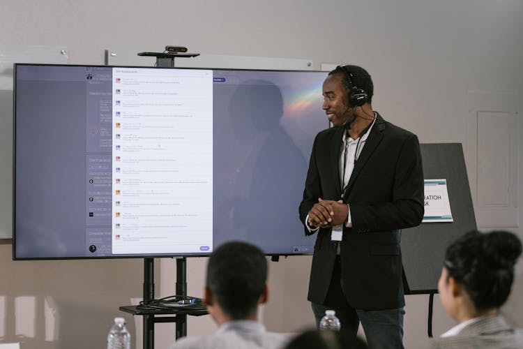 
A Man In A Suit Doing A Digital Presentation