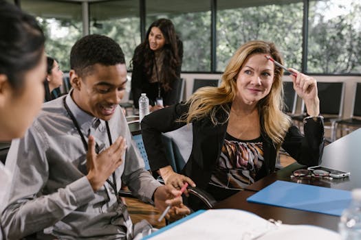 Professionals engaged in a collaborative discussion around a conference table in an office environment.