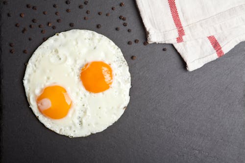 Free 
A Close-Up Shot of a Sunny Side Up Egg with Two Egg Yolks Stock Photo