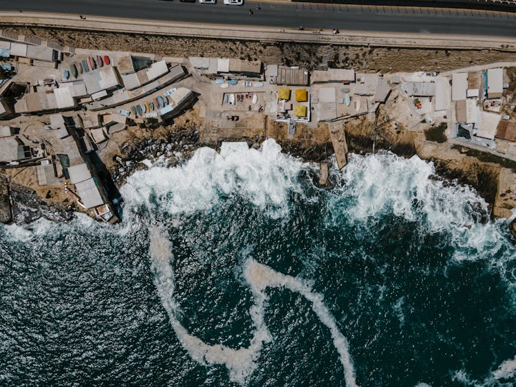 Ocean Waves Crashing On Coast Near Buildings