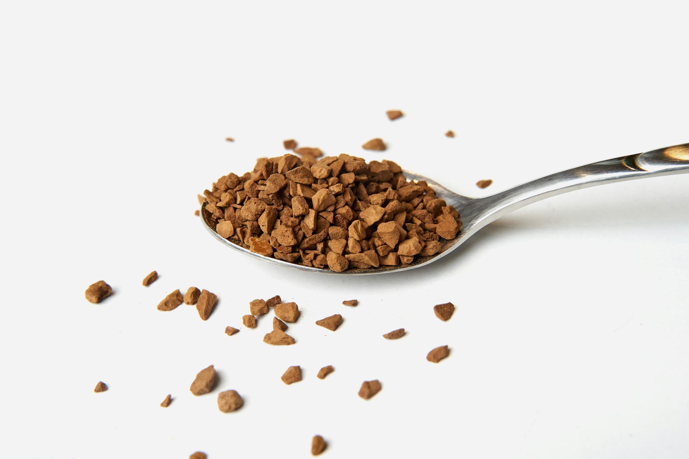 Brown instant Coffee Powder on Silver Spoon