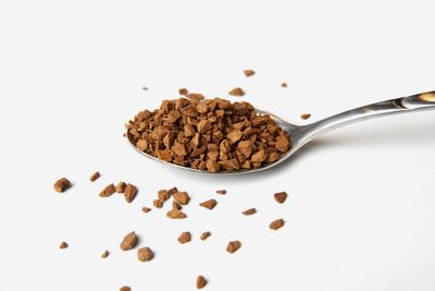 Instant espresso coffee granules on a spoon. Photo by Peter on Pexels.