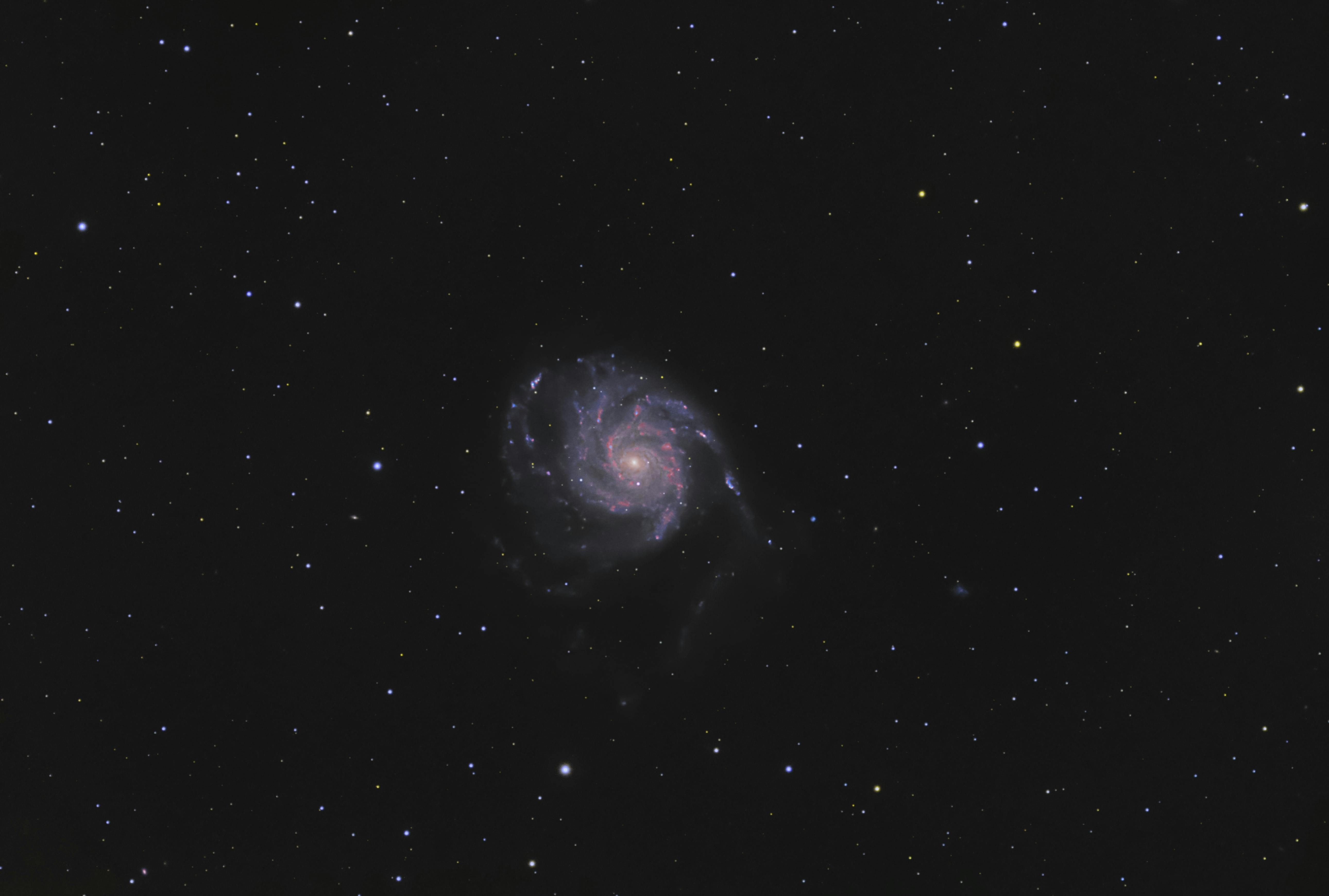 Mesmerizing astrophotography of a spiral galaxy surrounded by sparkling stars in a clear night sky.