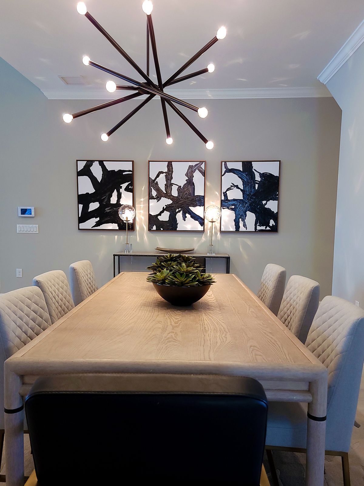 Elegant Hamptons dining room with soft upholstered chairs and a wood table