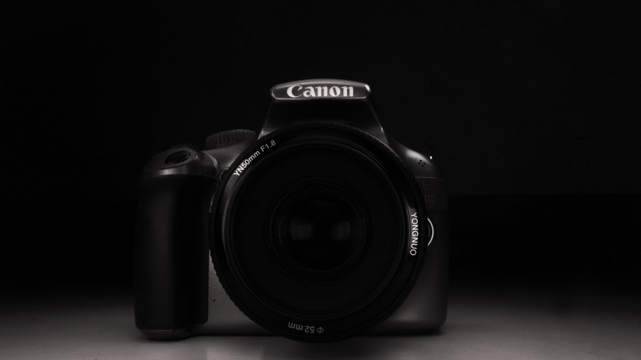 Grayscale Photo of a Canon Camera · Free Stock Photo