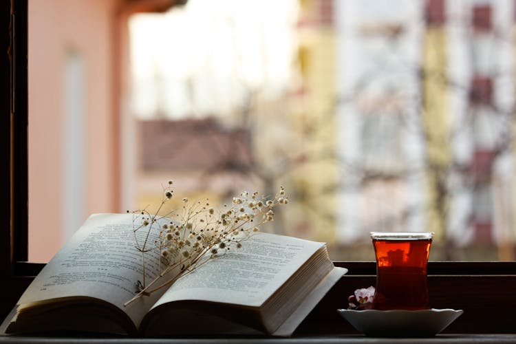 Cup Of Tea And A Book On Window Sill