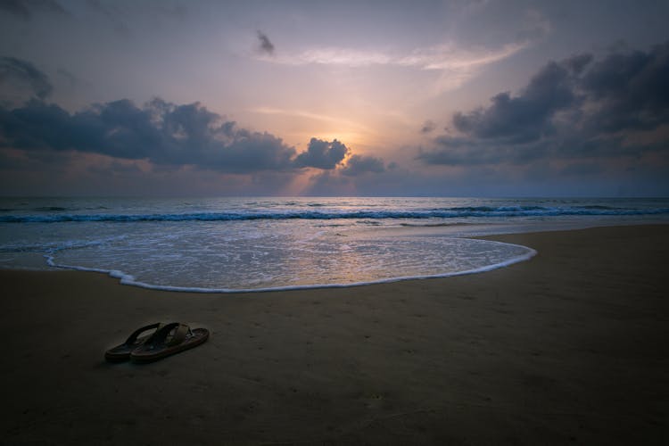 Pair Of Slippers On Shore