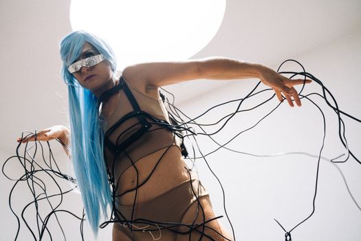 Artistic portrayal of a futuristic woman entangled in wires with a cyberpunk aesthetic.