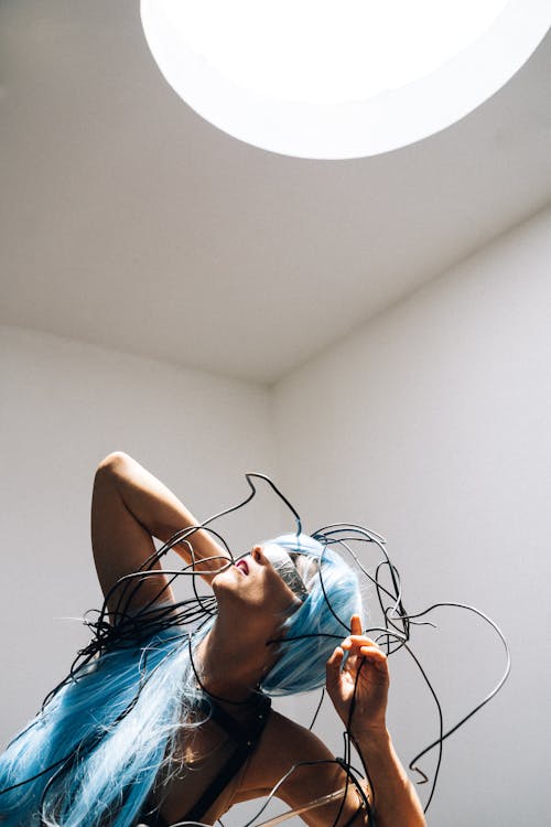 Woman Wearing a Blue Wig Staring at the Light