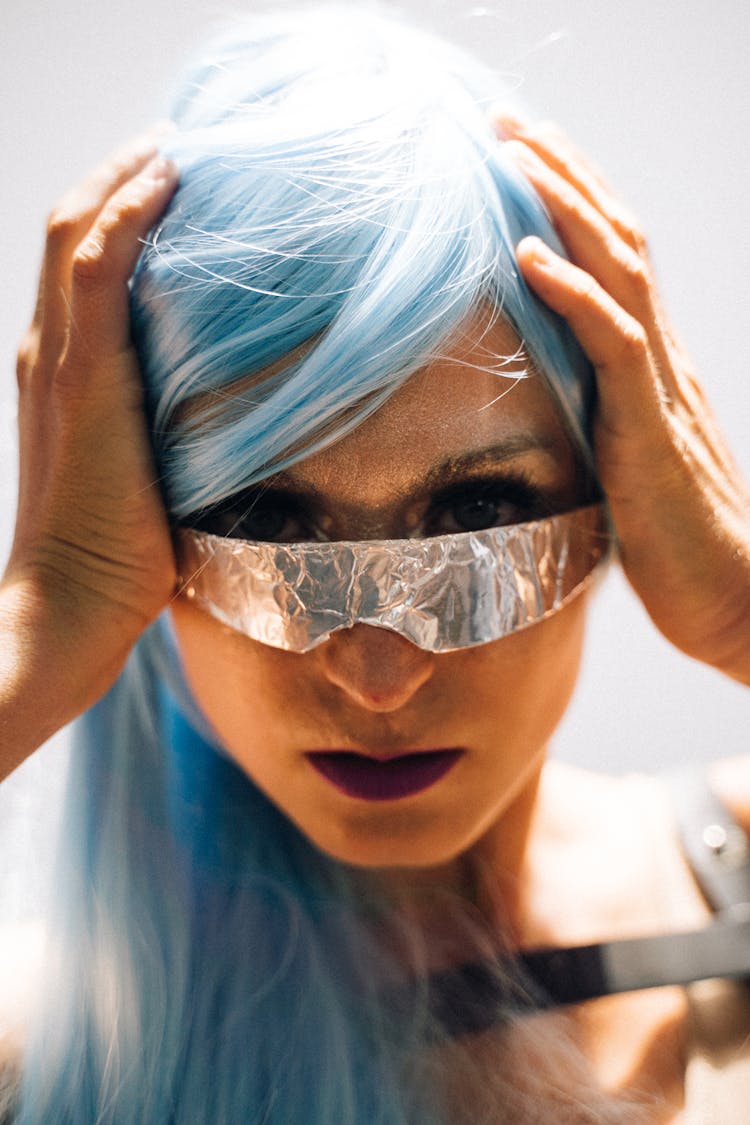 Woman Wearing A Foil Eyewear With Hands On Head